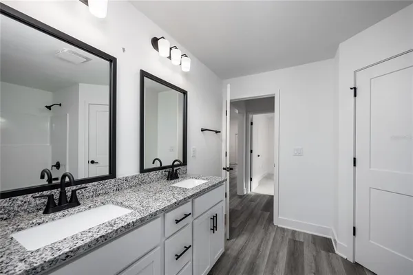 a bathroom with a granite countertop sink and a mirror