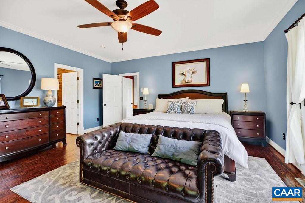 1059 Bryant Mountain Road Roseland, VA 22967 - Photo 21 of 58 a bedroom with a bed and dresser with wooden floor