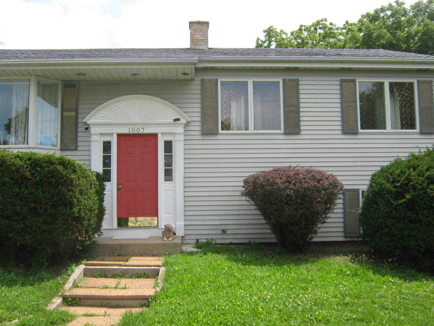 1007 Prairie Lawn Road Glenview, IL 60025 - Photo 4 of 48 a front view of a house with a garden
