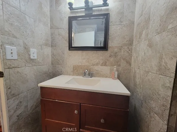 a bathroom with a sink a mirror and shower