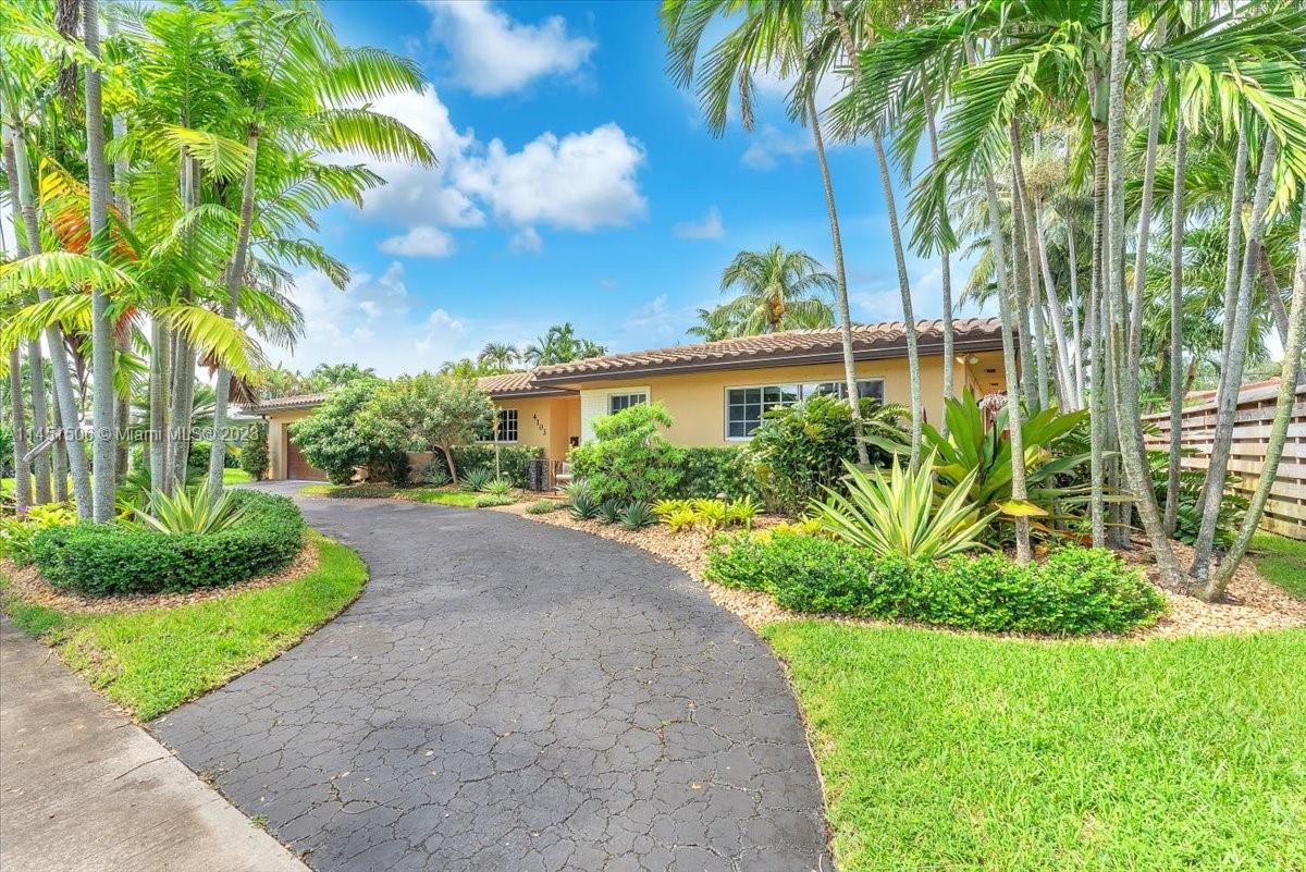 4103 Polk Street Hollywood, FL 33021 - Photo 1 of 55 a front view of a house with a yard and fountain