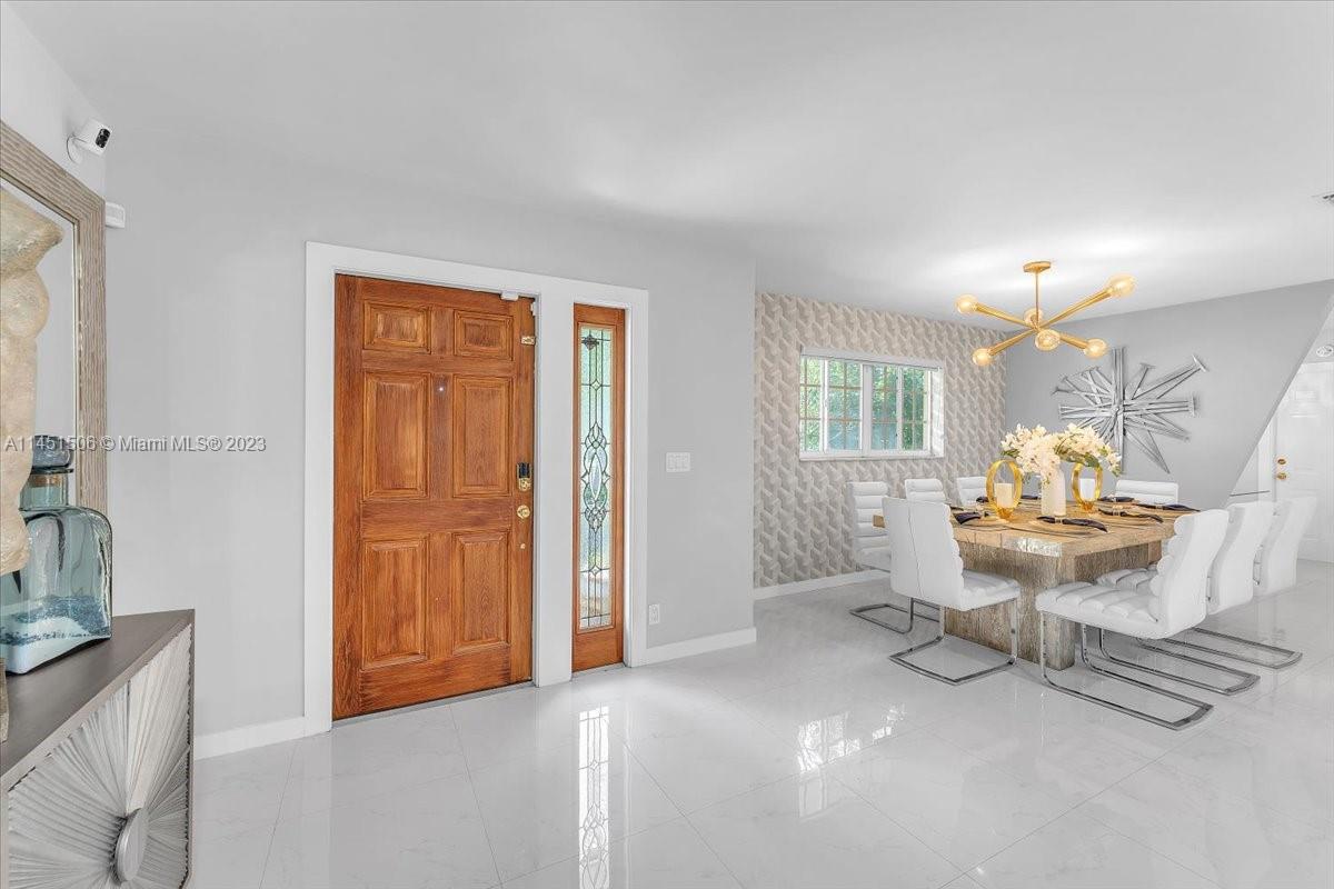 4103 Polk Street Hollywood, FL 33021 - Photo 17 of 55 a living room with furniture and a table