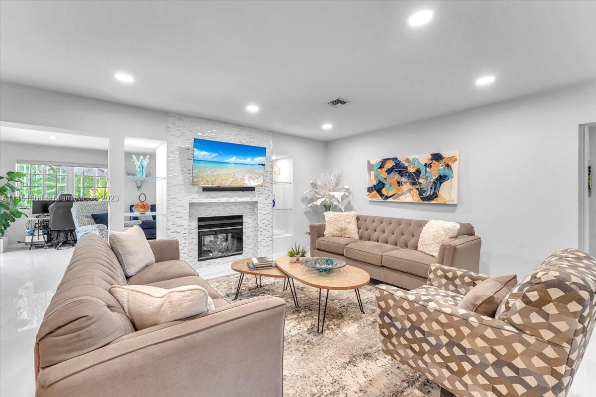 4103 Polk Street Hollywood, FL 33021 - Photo 19 of 55 a living room with furniture a rug and a fireplace