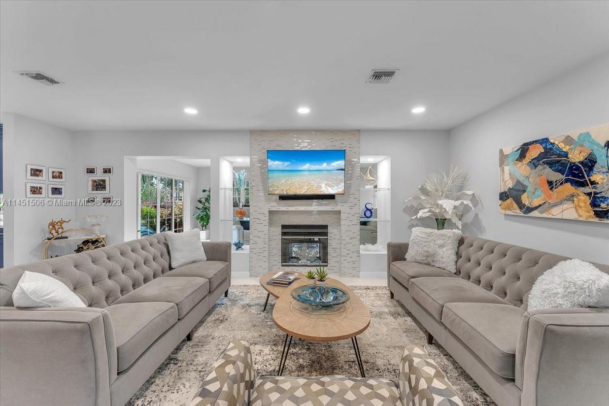 4103 Polk Street Hollywood, FL 33021 - Photo 20 of 55 a living room with furniture and a fireplace