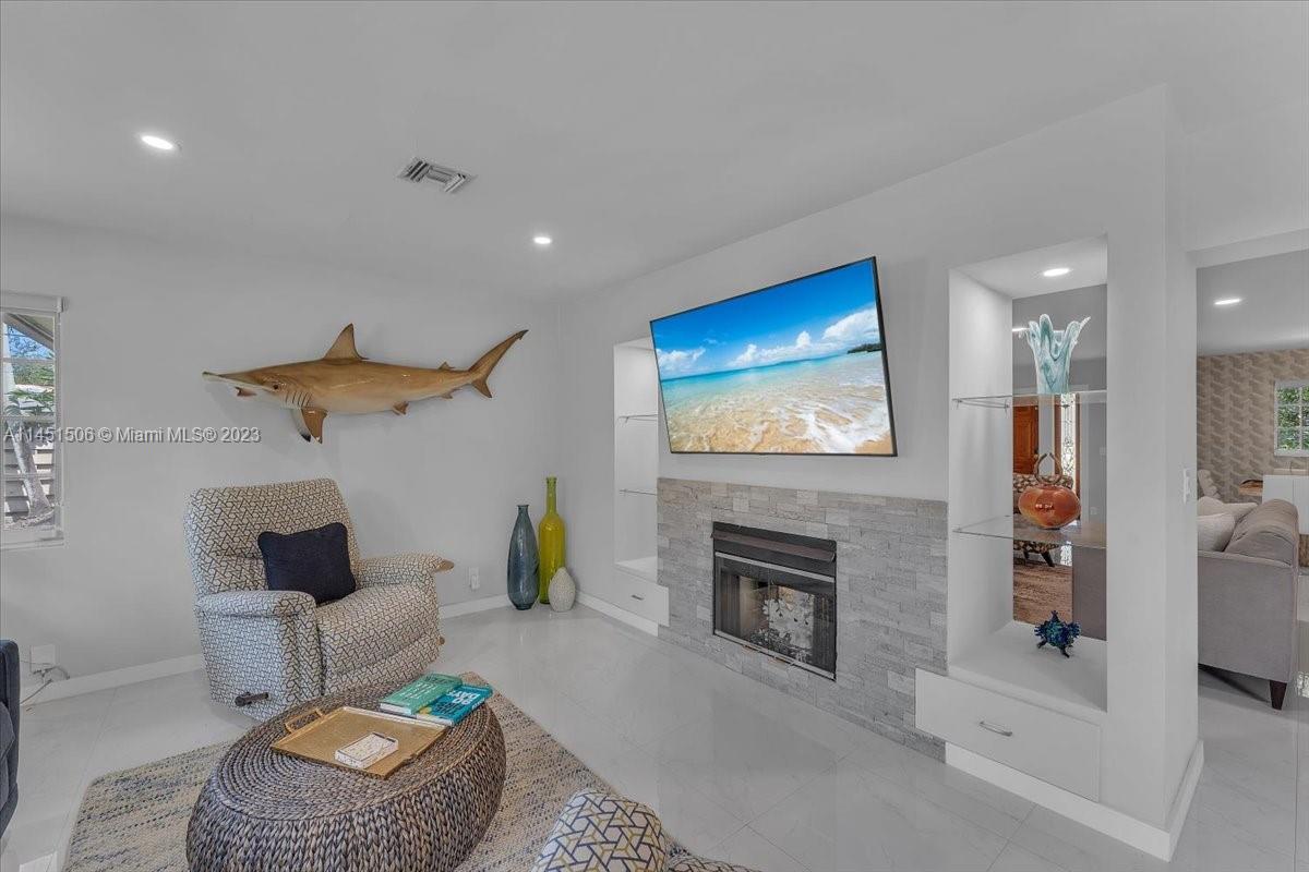 4103 Polk Street Hollywood, FL 33021 - Photo 21 of 55 a living room with furniture a fireplace and a flat screen tv