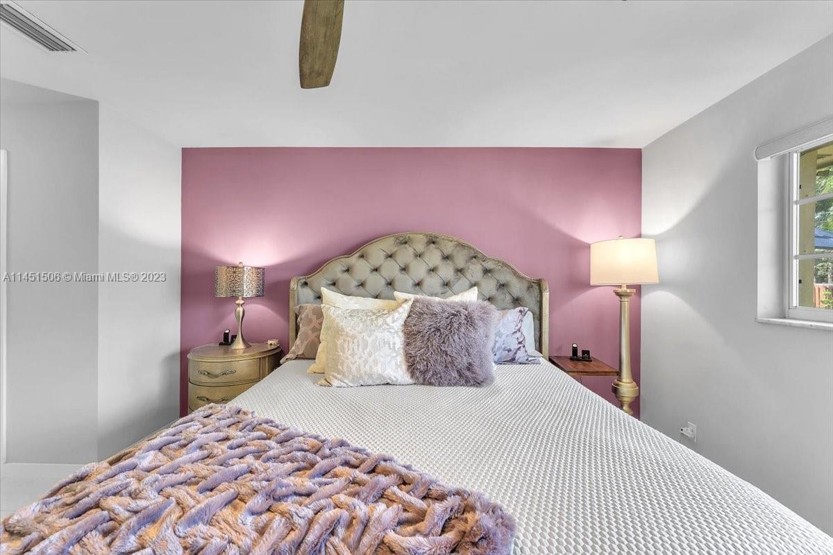 4103 Polk Street Hollywood, FL 33021 - Photo 25 of 55 a bedroom with a bed and a chandelier