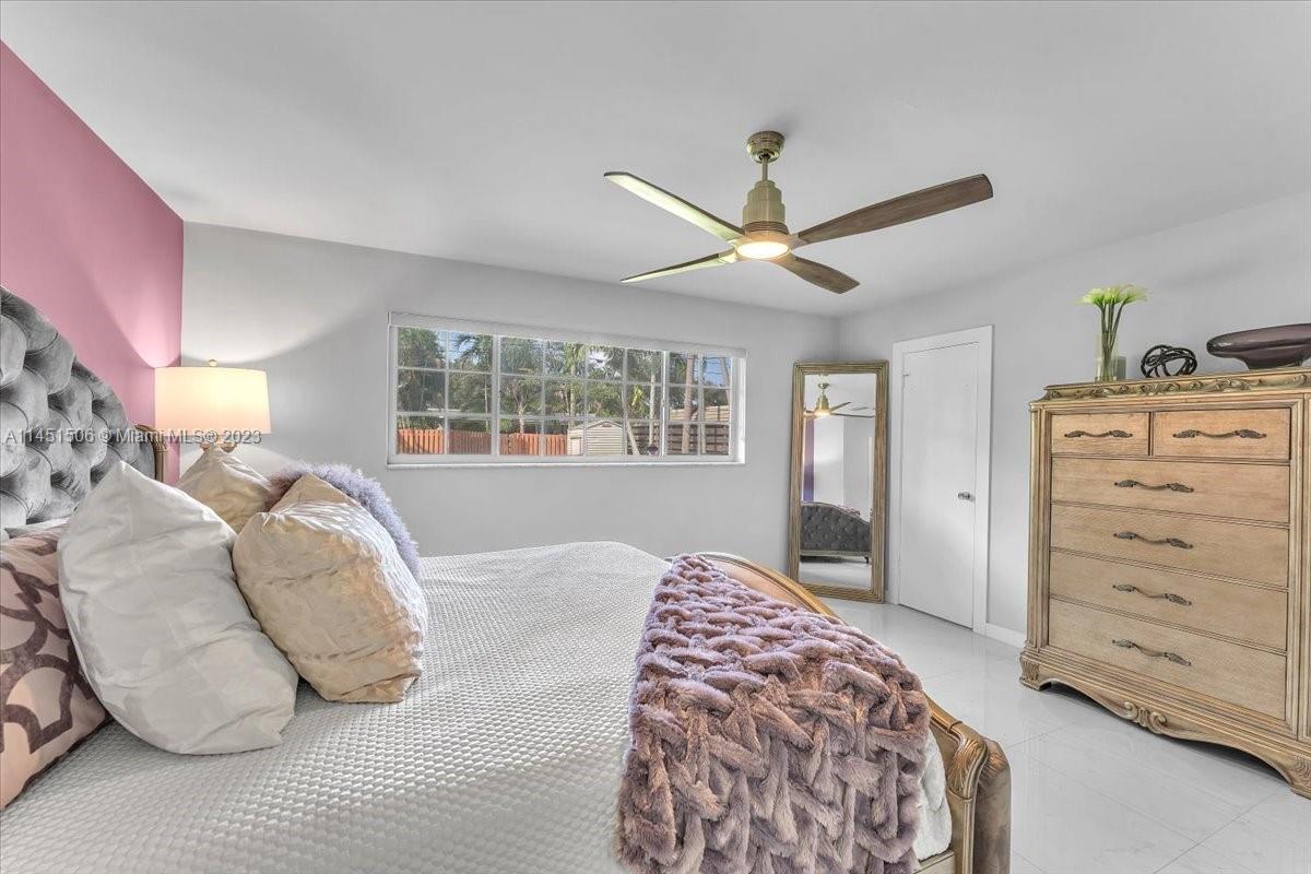 4103 Polk Street Hollywood, FL 33021 - Photo 27 of 55 a bedroom with a large bed and a window