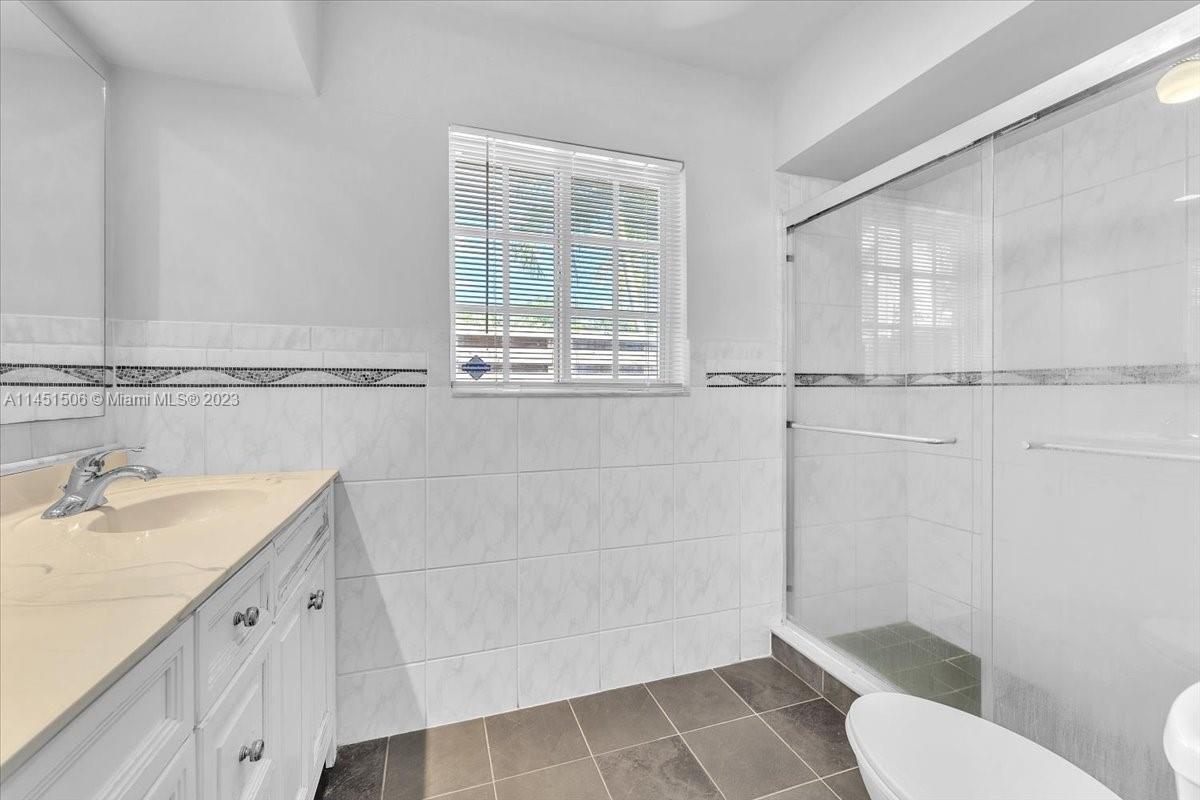 4103 Polk Street Hollywood, FL 33021 - Photo 28 of 55 a bathroom with a sink toilet and shower
