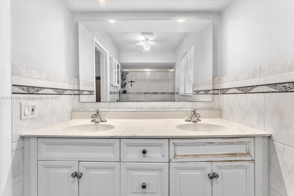 4103 Polk Street Hollywood, FL 33021 - Photo 29 of 55 a bathroom with a sink double vanity and a mirror