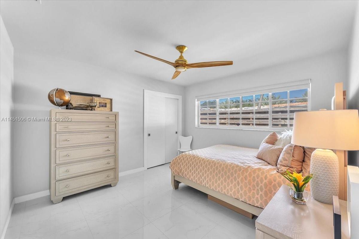4103 Polk Street Hollywood, FL 33021 - Photo 30 of 55 a bedroom with a bed a dresser and a window