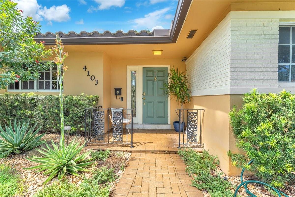 4103 Polk Street Hollywood, FL 33021 - Photo 3 of 55 a front view of a house with a yard