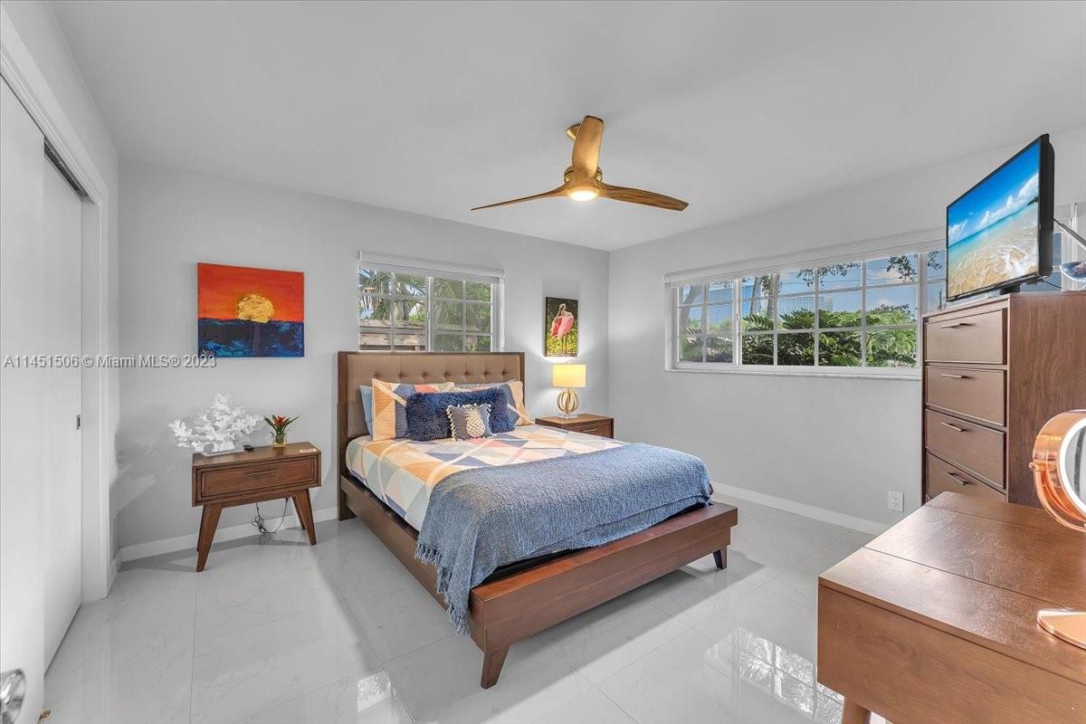 4103 Polk Street Hollywood, FL 33021 - Photo 32 of 55 a bedroom with a bed and a flat screen tv