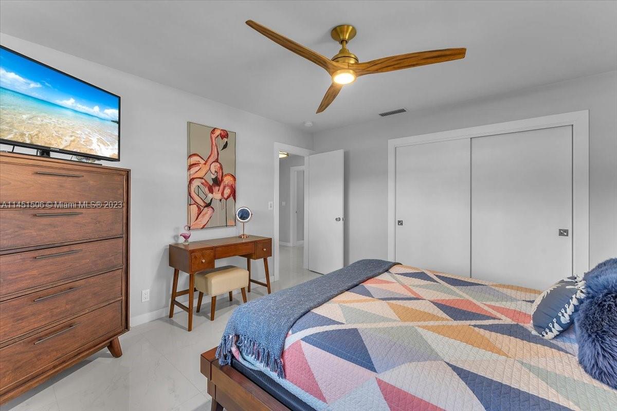 4103 Polk Street Hollywood, FL 33021 - Photo 33 of 55 a bedroom with a bed and a flat screen tv