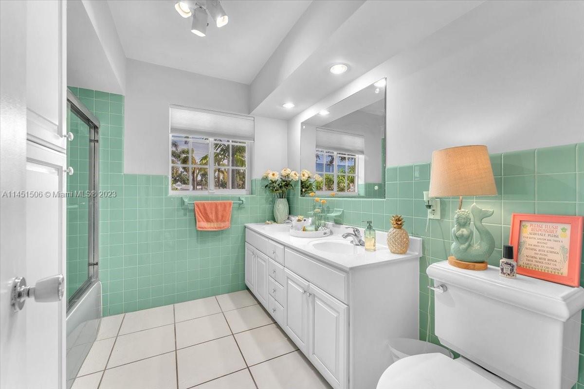 4103 Polk Street Hollywood, FL 33021 - Photo 34 of 55 a bathroom with a sink a toilet and a mirror