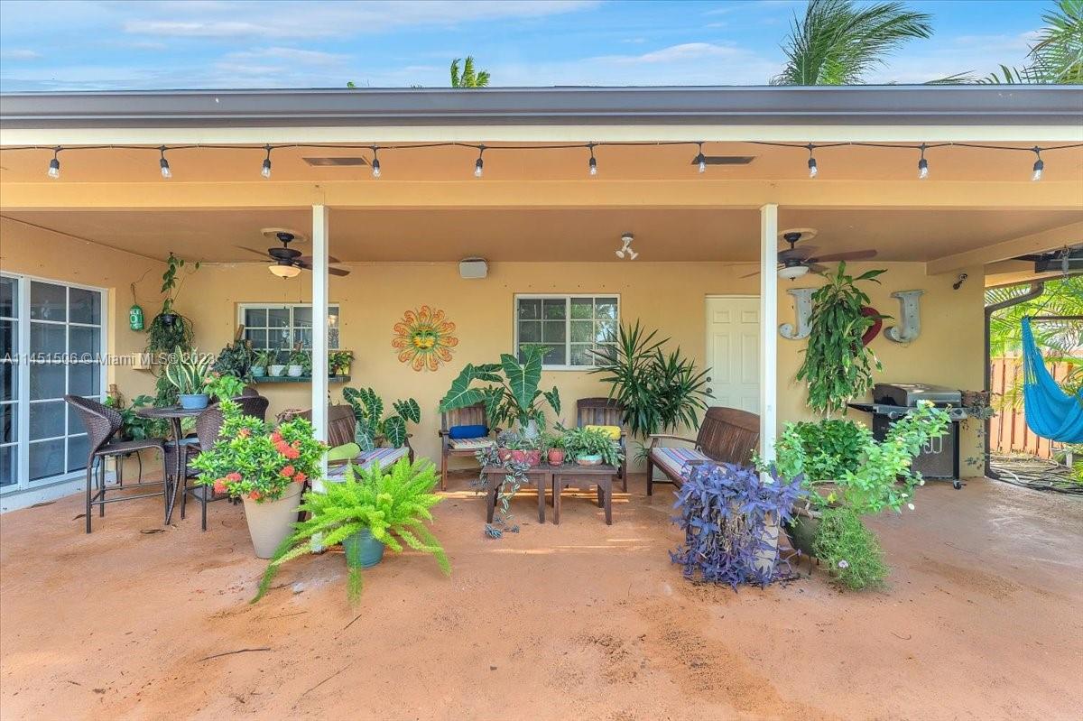 4103 Polk Street Hollywood, FL 33021 - Photo 38 of 55 a view of a porch with chairs and potted plants