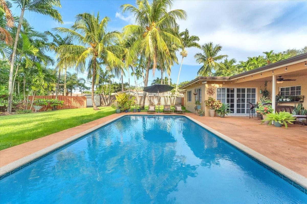 4103 Polk Street Hollywood, FL 33021 - Photo 42 of 55 a swimming pool with outdoor seating and yard