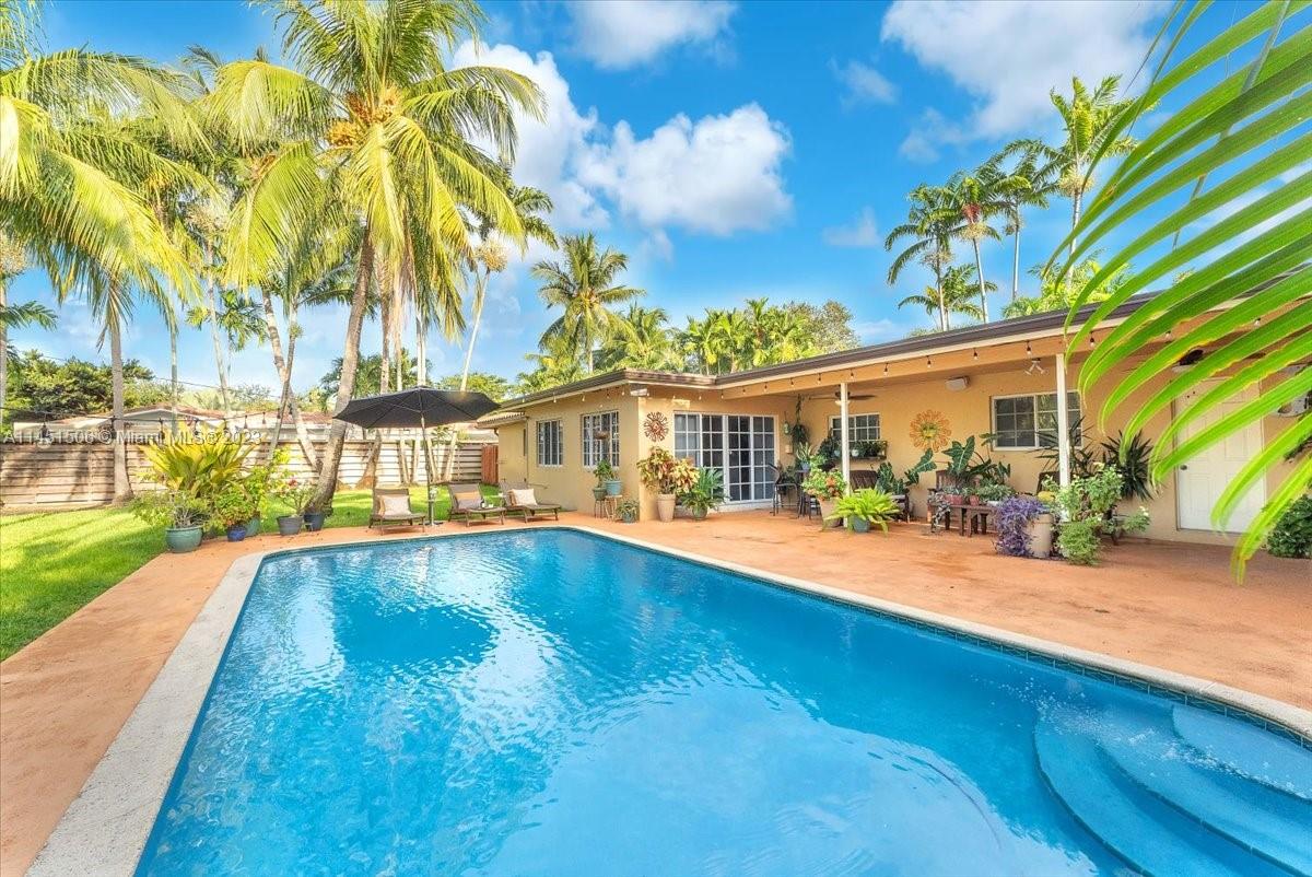 4103 Polk Street Hollywood, FL 33021 - Photo 43 of 55 a view of swimming pool with outdoor seating and a garden