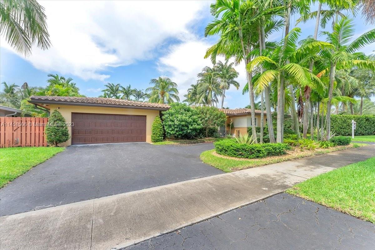 4103 Polk Street Hollywood, FL 33021 - Photo 55 of 55 a view of a house with a yard and palm trees