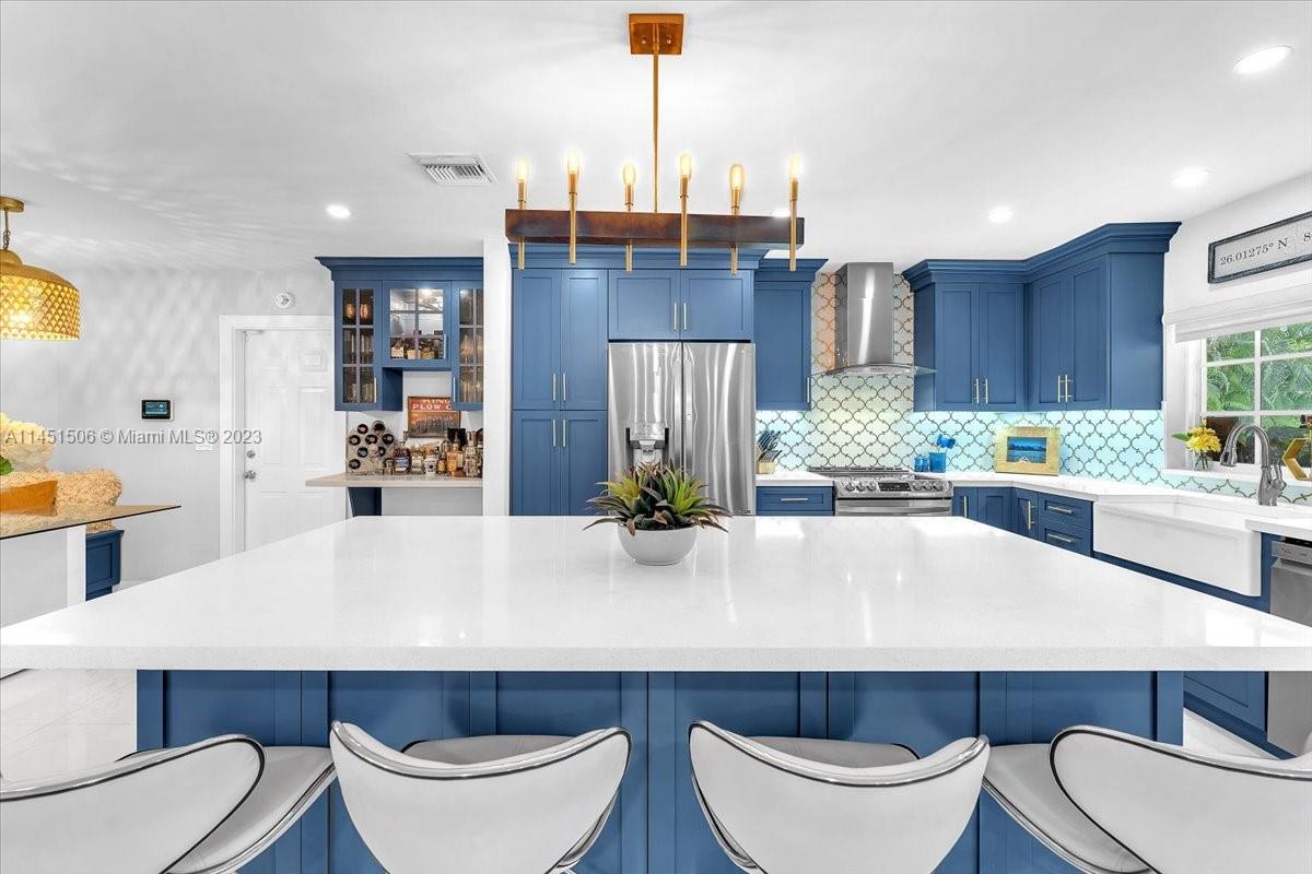 4103 Polk Street Hollywood, FL 33021 - Photo 8 of 55 a kitchen with a table chairs sink and cabinets
