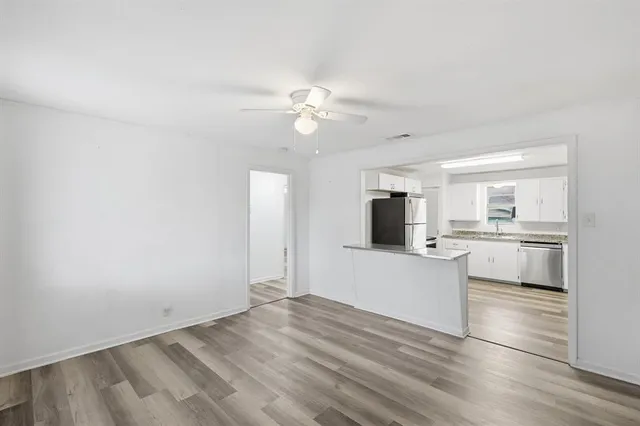 a view of a kitchen with wooden floor and a kitchen