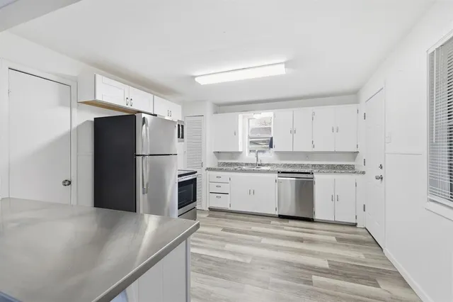 a kitchen with a refrigerator and a sink