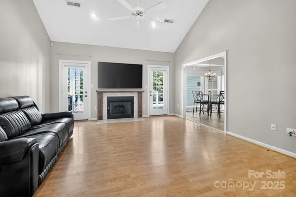 a living room with furniture a flat screen tv and a fireplace
