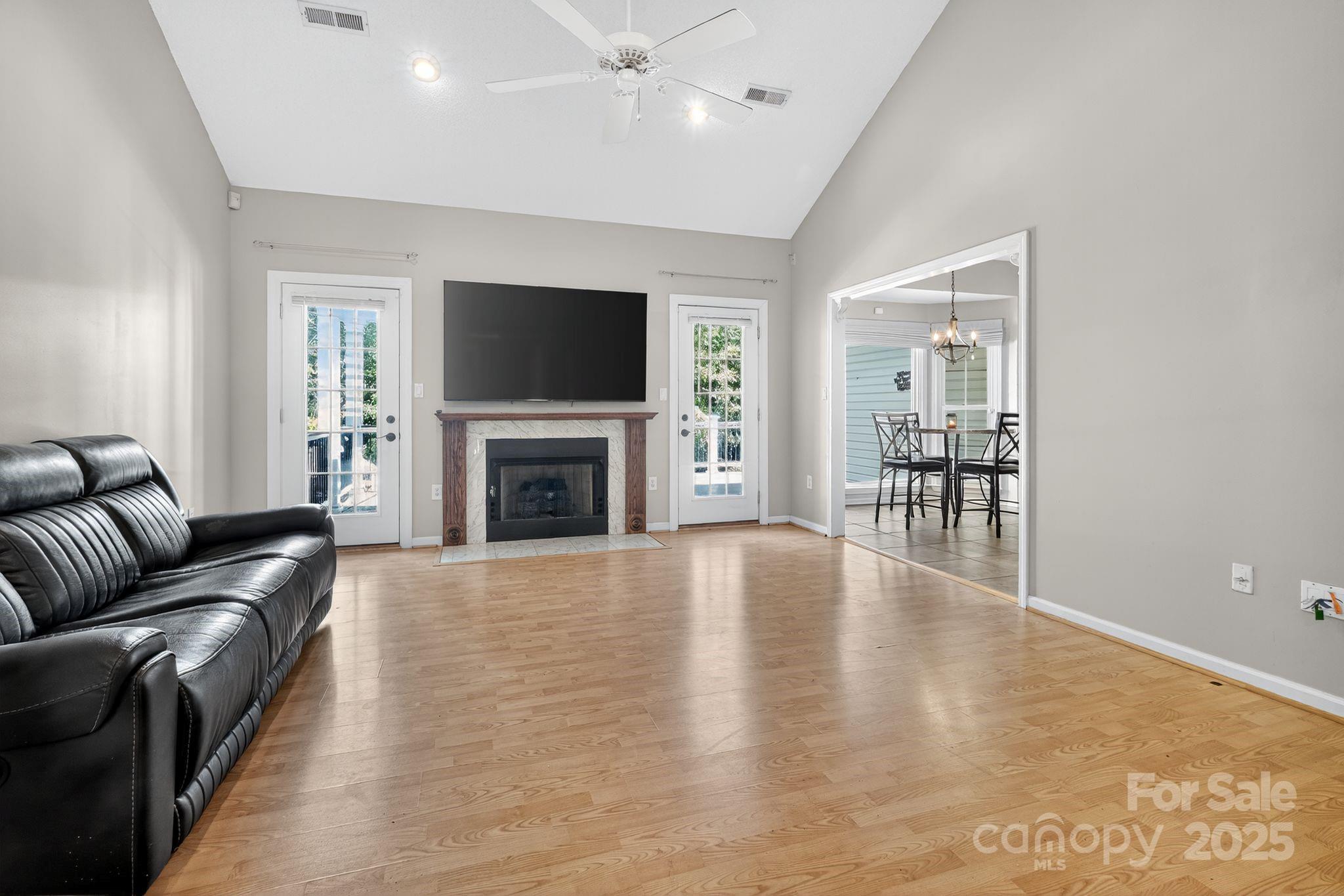 208 Stone Ridge Drive Salisbury, NC 28146 - Photo 11 of 35 a living room with furniture a flat screen tv and a fireplace