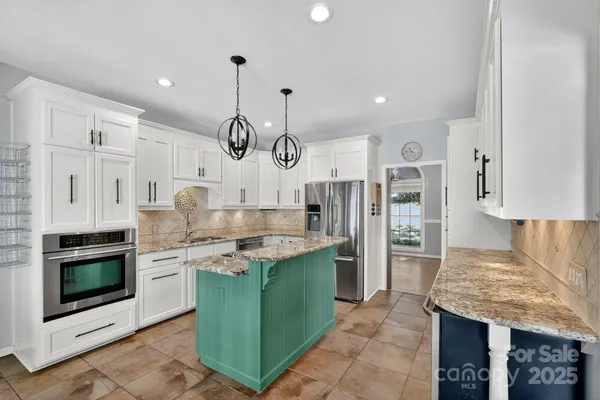 a kitchen with cabinets and stainless steel appliances