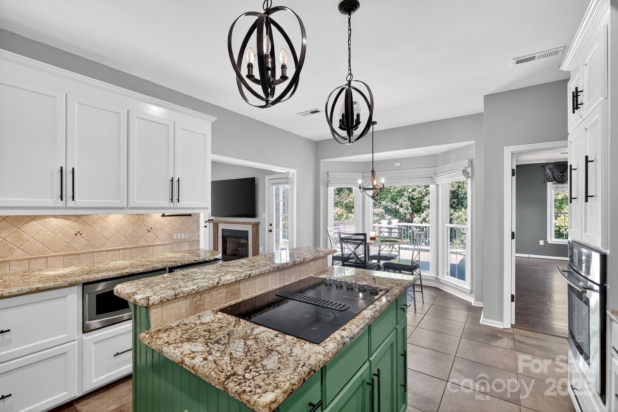 208 Stone Ridge Drive Salisbury, NC 28146 - Photo 15 of 35 a kitchen with stainless steel appliances granite countertop a stove oven and a view of living room