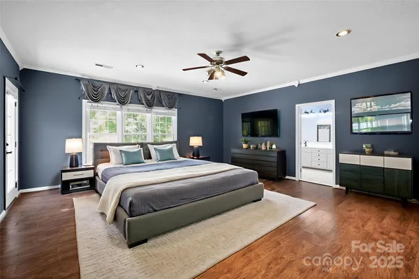 a bedroom with a large bed and a tv