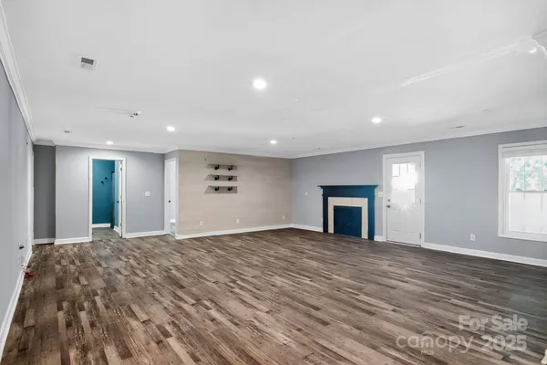 a view of a livingroom with a fireplace and window