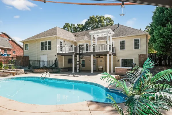 a view of a house with swimming pool and porch
