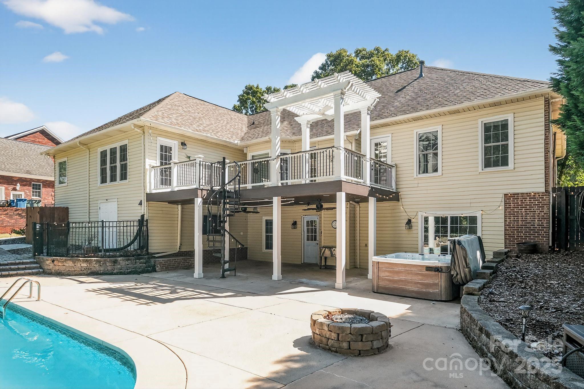 208 Stone Ridge Drive Salisbury, NC 28146 - Photo 6 of 35 a view of a white house with couches chairs and a yard