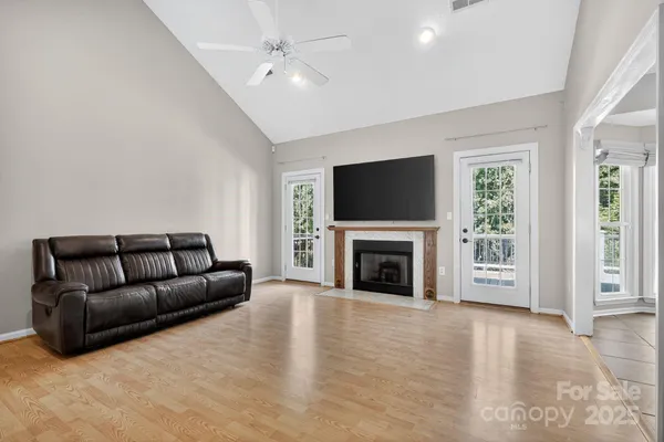 a living room with furniture a fireplace and a flat screen tv