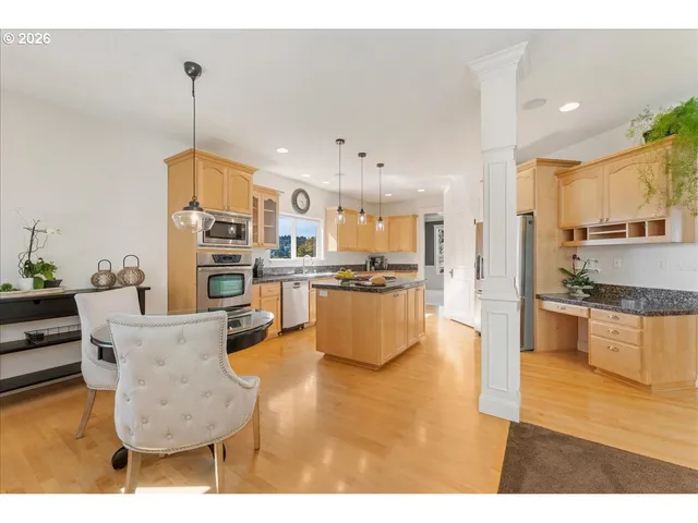 a open kitchen with cabinets and stainless steel appliances