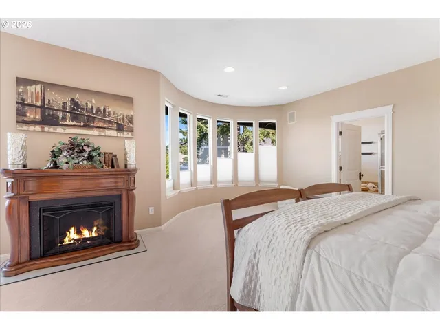 a spacious bedroom with a bed and a fireplace