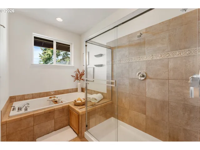 a bathroom with a tub sink and mirror