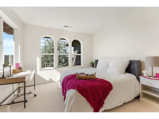 a bed room with a bed and a large window