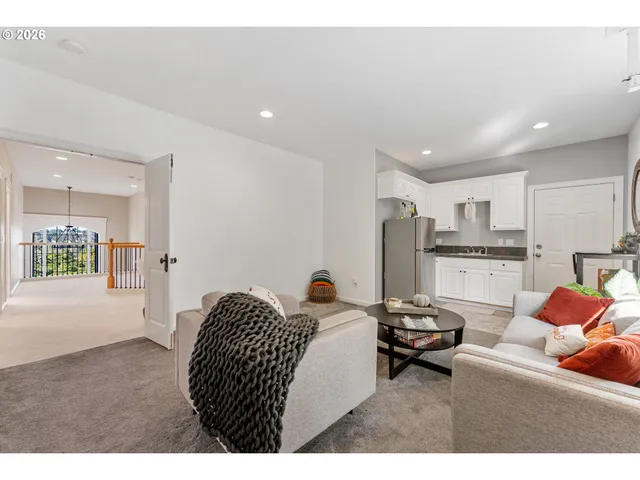 a living room with furniture and kitchen view
