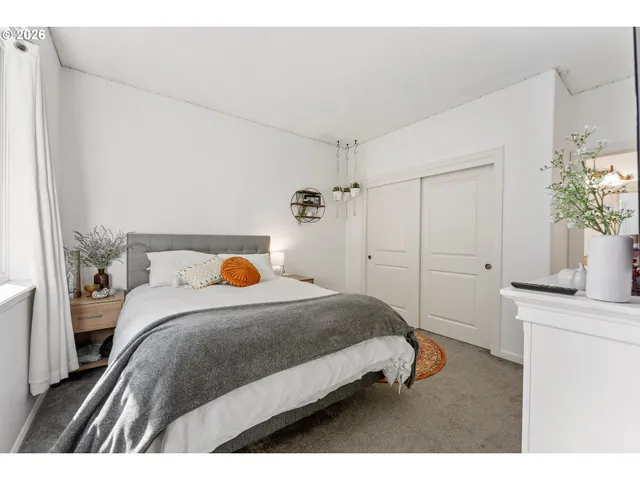 a bedroom with a bed and a potted plant