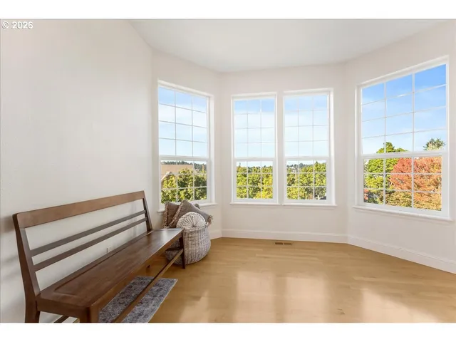 a view of wooden floor and windows in a room