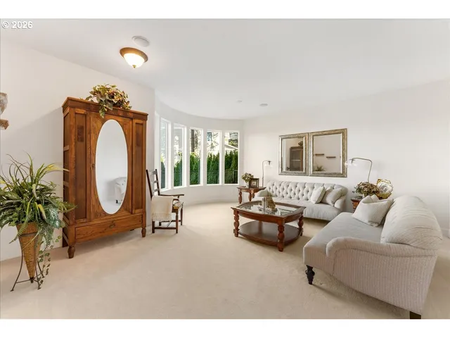 a living room with furniture a chandelier a glass door and a large window