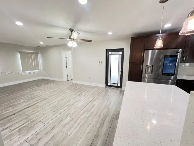 a view of a hallway with wooden floor