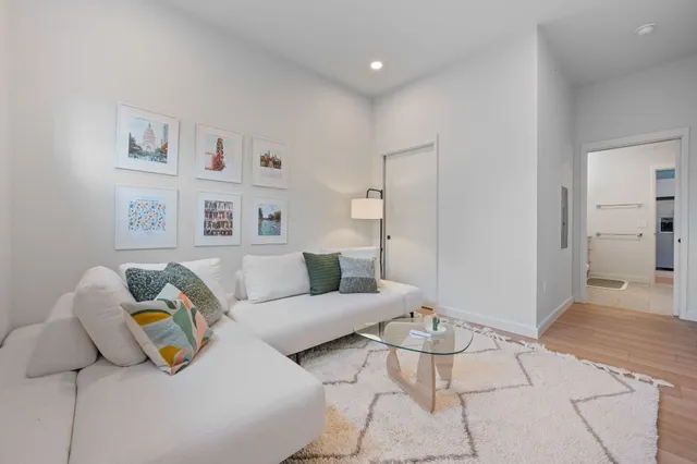 a living room with furniture and a rug