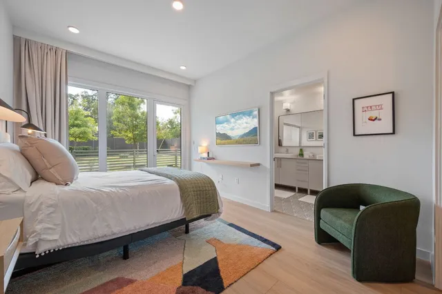 a spacious bedroom with a bed and a couch