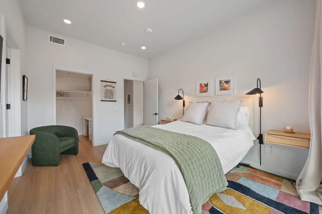 a bedroom with a bed and a couch