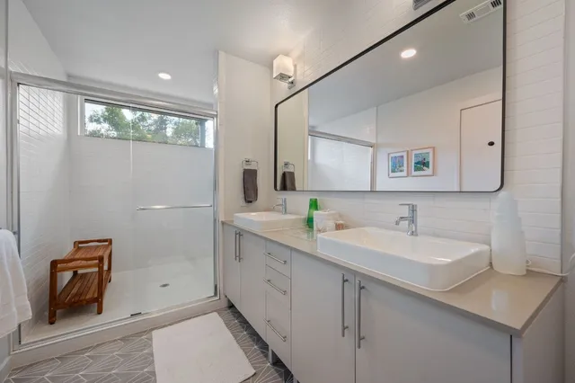a bathroom with a sink a toilet and mirror