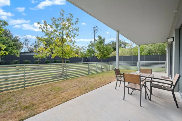 a view of a two chair and table in the backyard