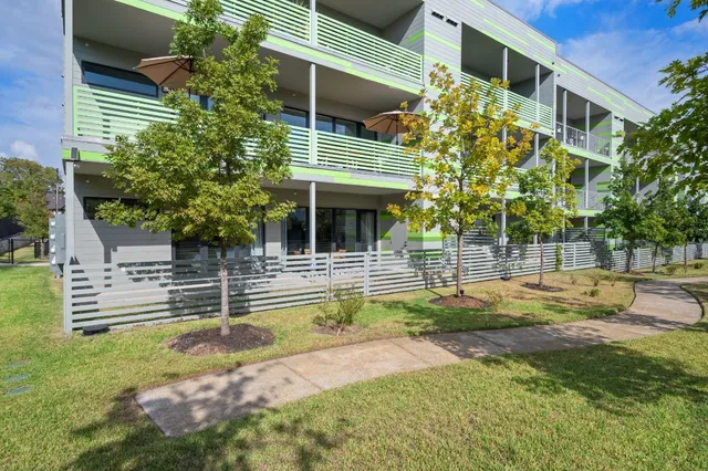 a view of house with a yard and sitting area