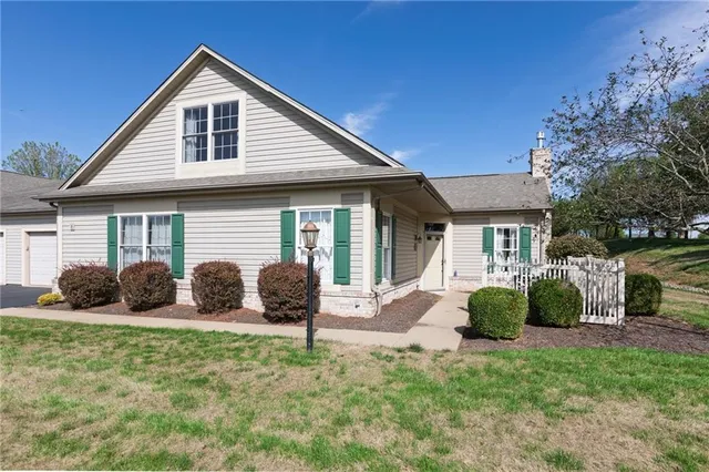 a front view of house with yard and outdoor seating